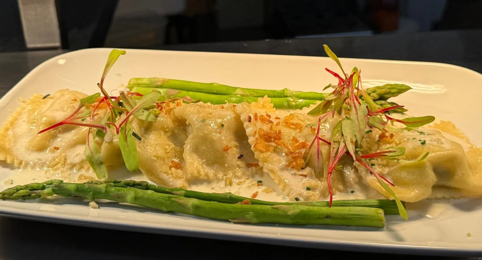 Handmade ravioli with asparagus and cream sauce